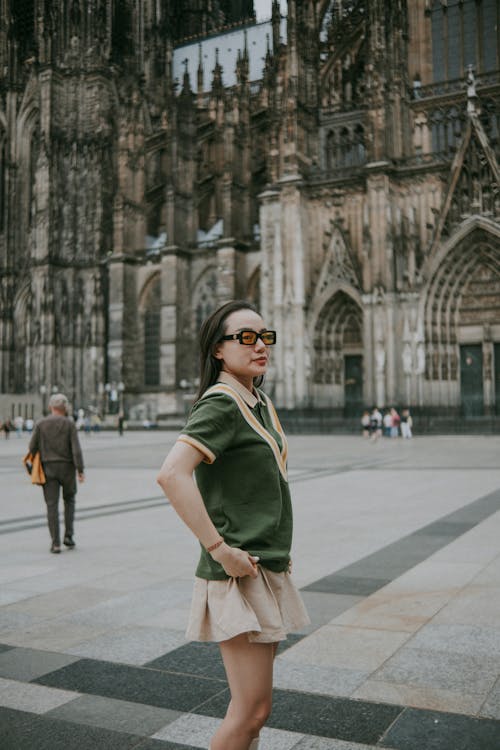 Woman in Gray Skirt Standing by Cologne Cathedral