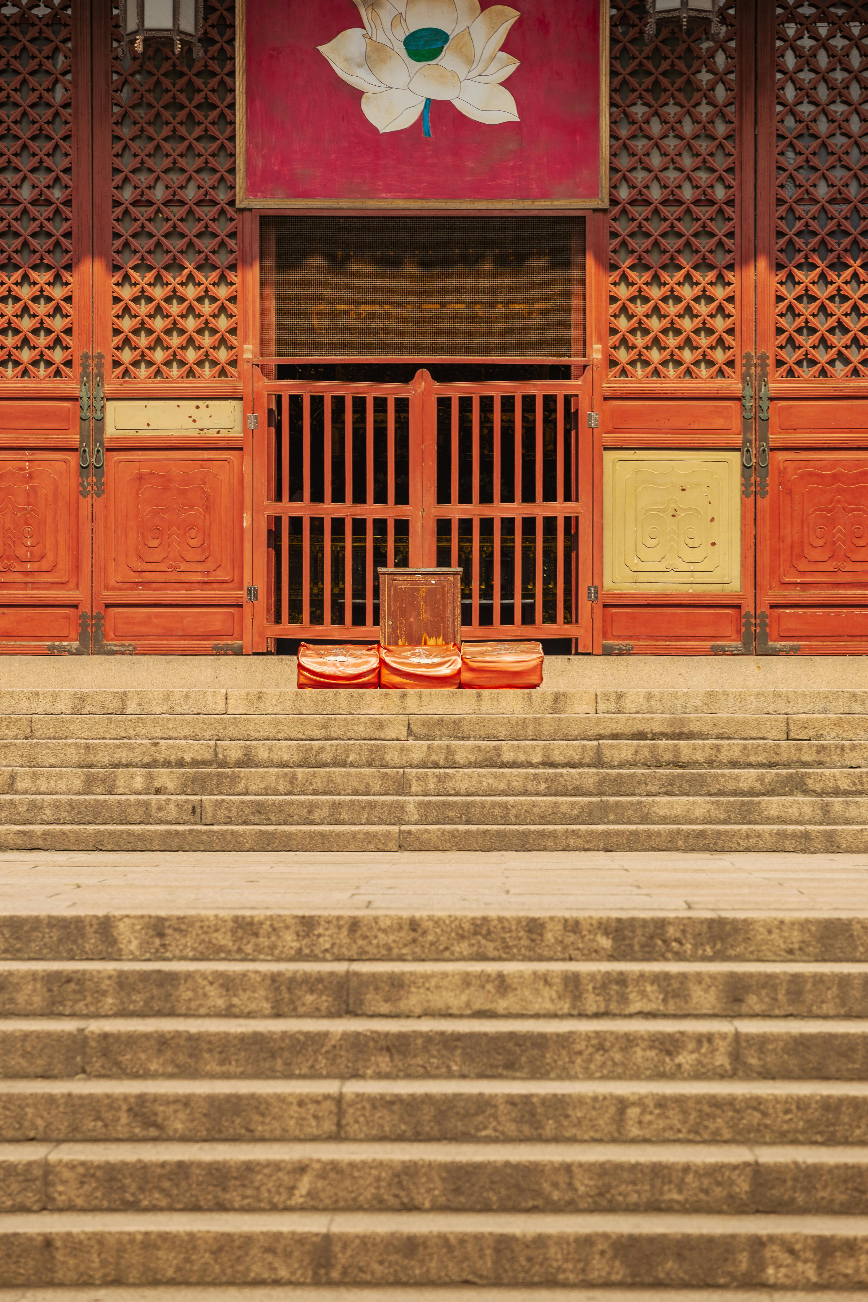 Elegant temple entrance with steps and seating for meditation, highlighting spiritual tranquility.