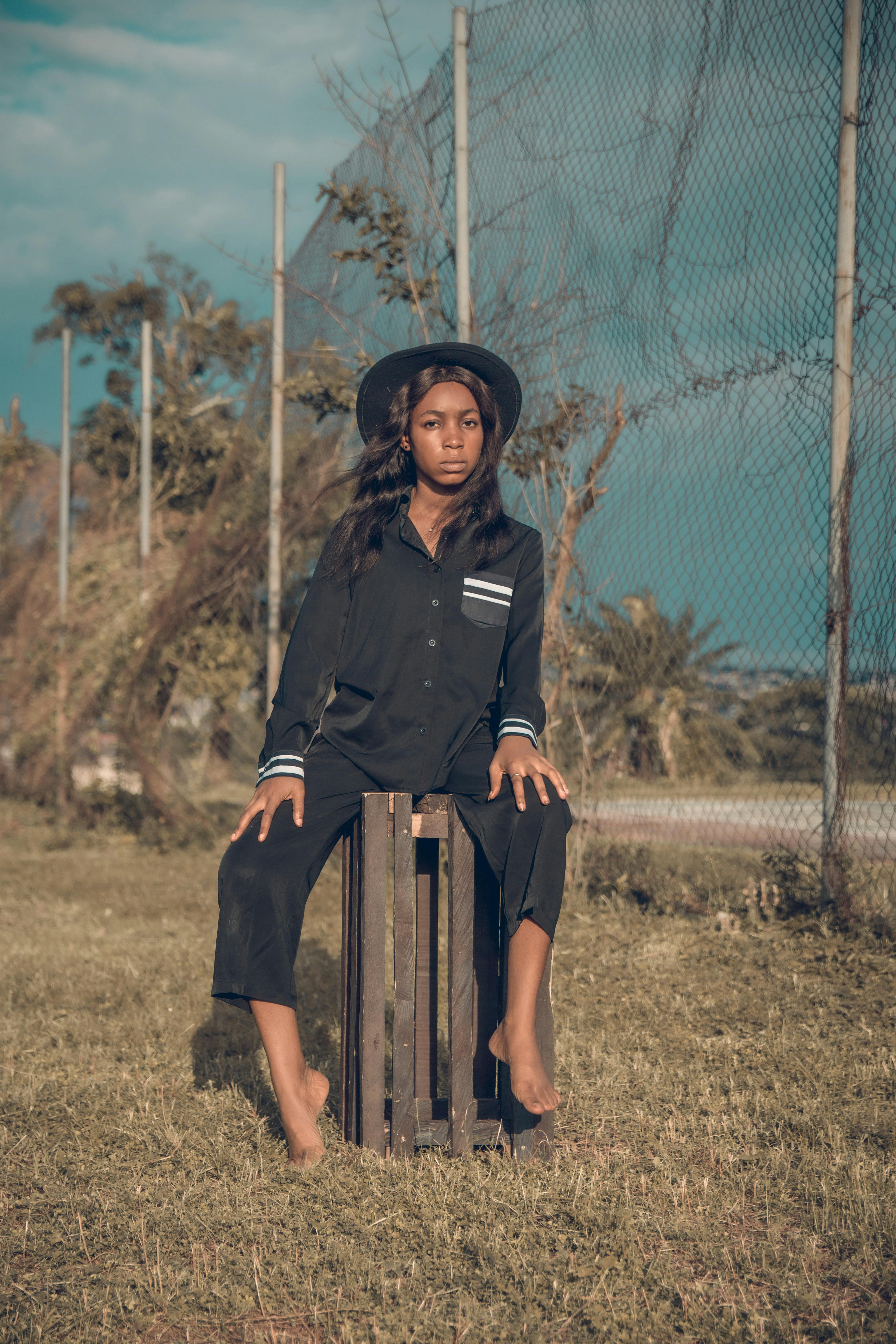 Woman Sitting on Crate ?? Free Stock Photo