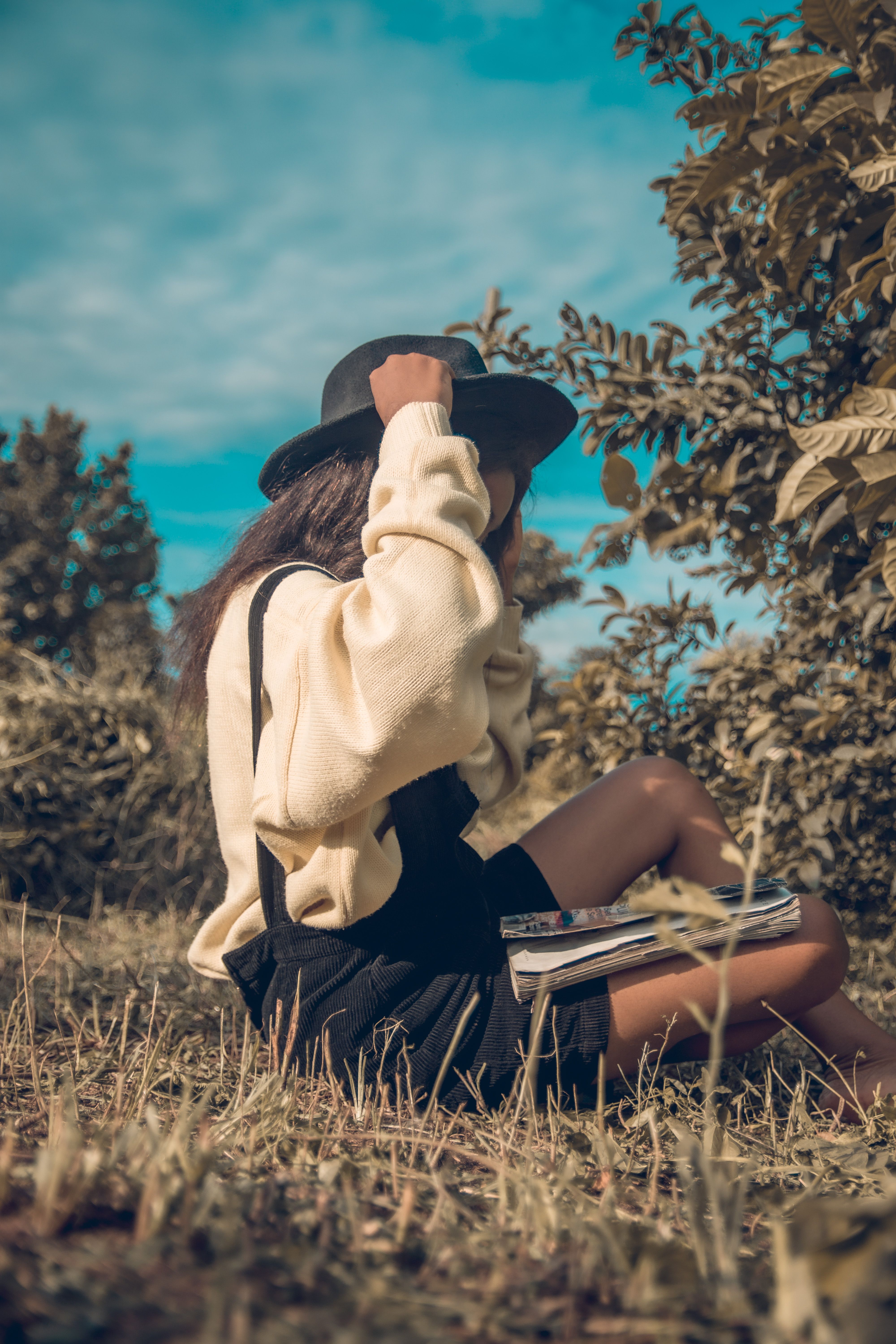 Woman in Hat Sitting on Grass · Free Stock Photo