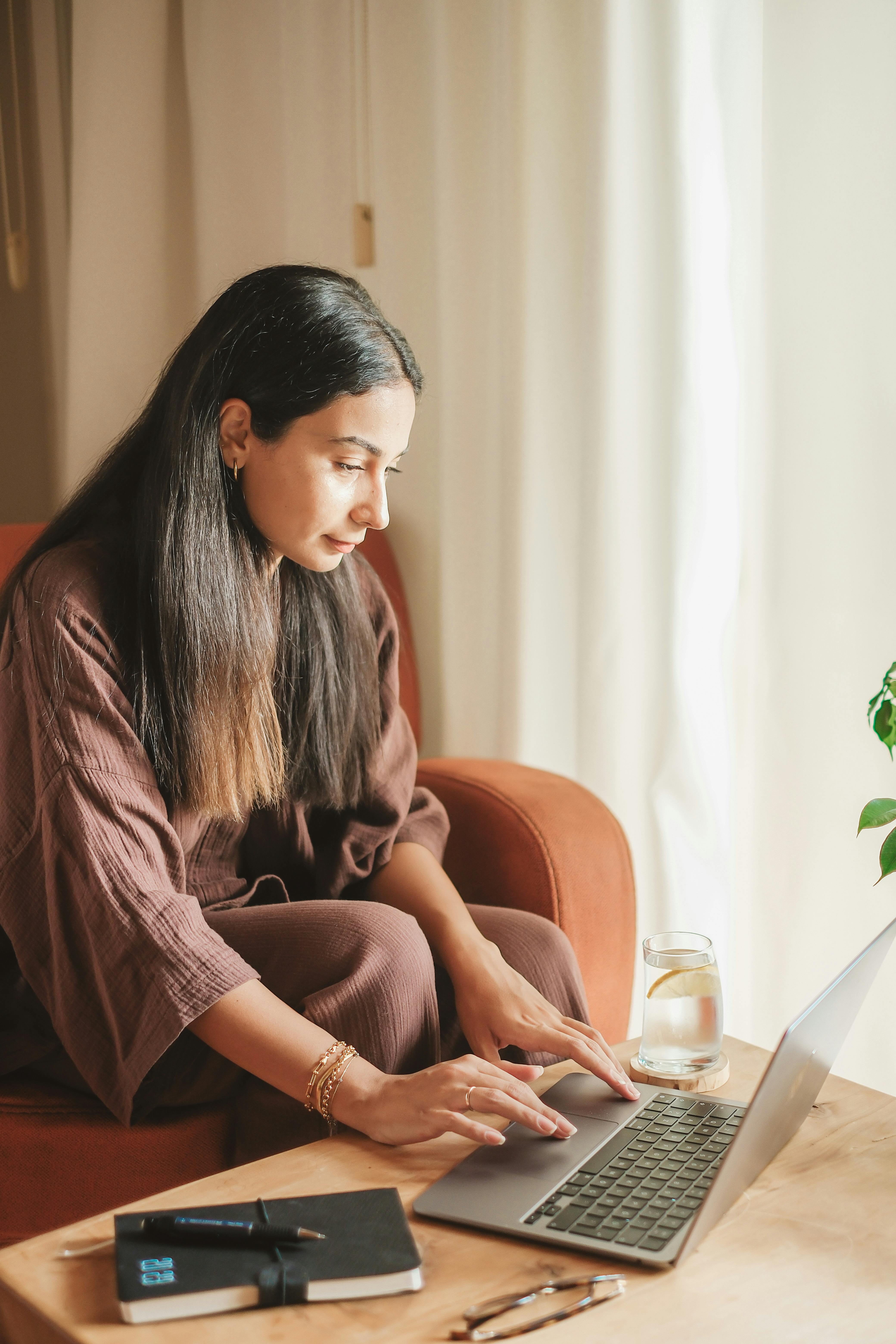 woman sitting and working on laptop