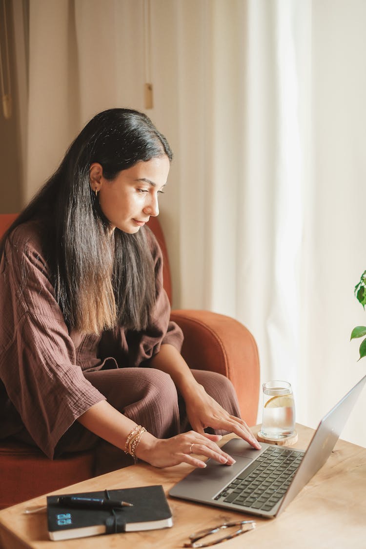 Woman Sitting And Working On Laptop