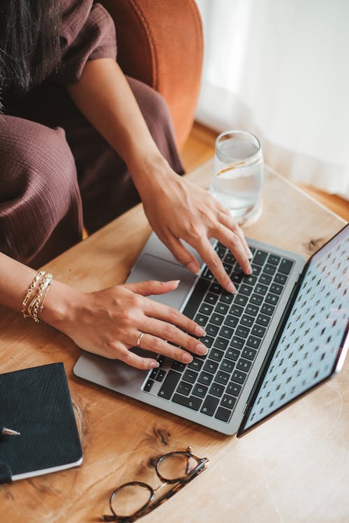 Woman Hands Typing on Laptop