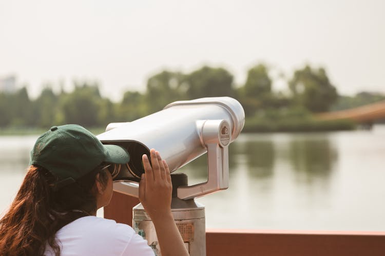 Woman Looking Through A Telescope 