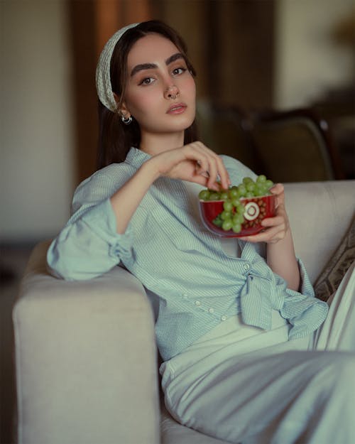 Free Woman Sitting with Bowl of Grapes Stock Photo