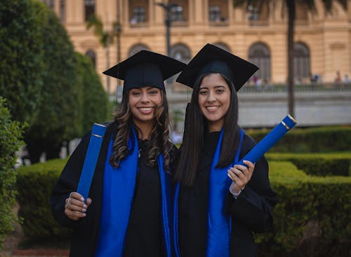Two Female Graduates Smiling at the Camera