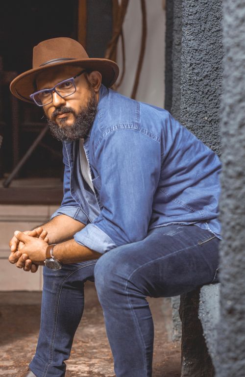 Free Portrait of a bearded man in denim and hat seated outside in Masaya, Nicaragua. Stock Photo