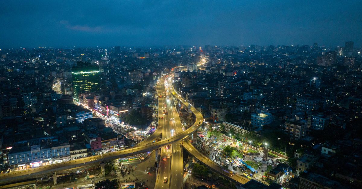 A mesmerizing aerial view of a city's bright streets and modern skyline at night.