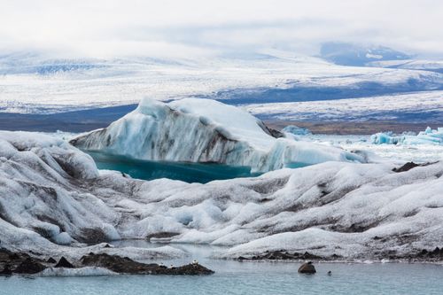 Free Majestic iceberg surrounded by winter landscape, capturing nature's icy beauty. Stock Photo