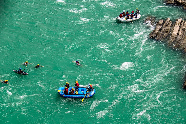 Group Of Man In A Pontoon In A River 