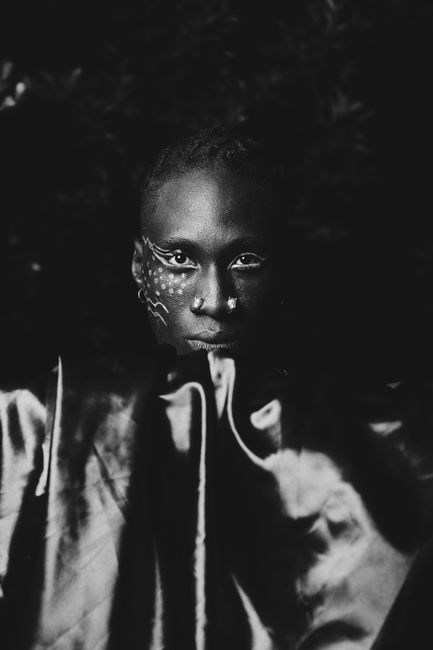 Striking monochrome portrait showcasing face paint artistry.