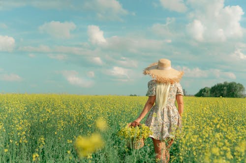 Woman Wearing Straw Hat on a Field 