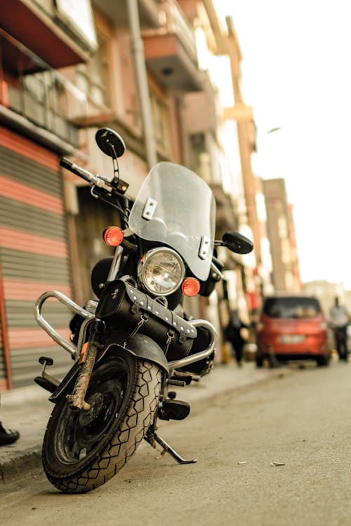 A Motorcycle Parked on the Side of the Street 