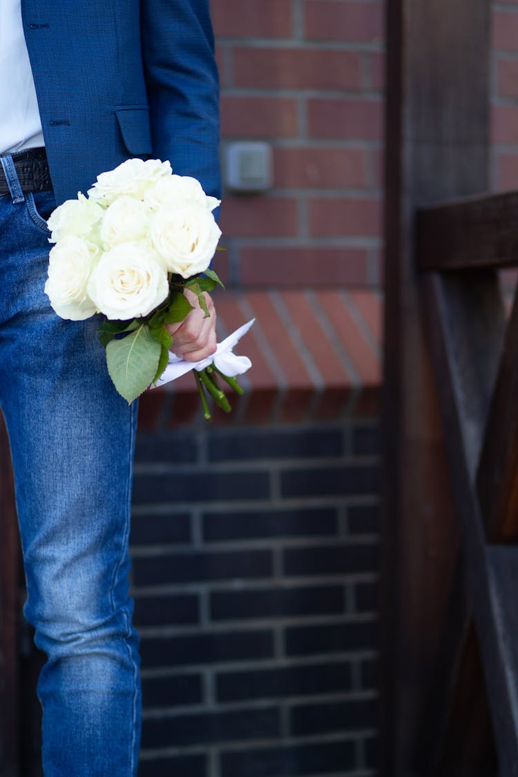 Man Holding A Bouquet Of White Roses 