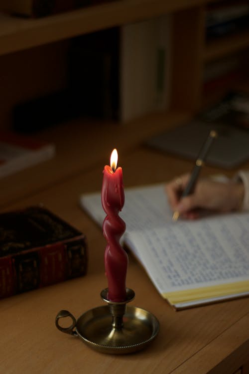 Lit Red Candle in a Brass Candle Holder