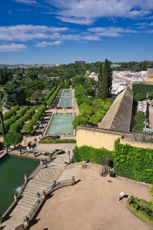 Free Aerial shot of Alcazar Gardens in Cordoba showcasing lush greenery and historic architecture. Stock Photo