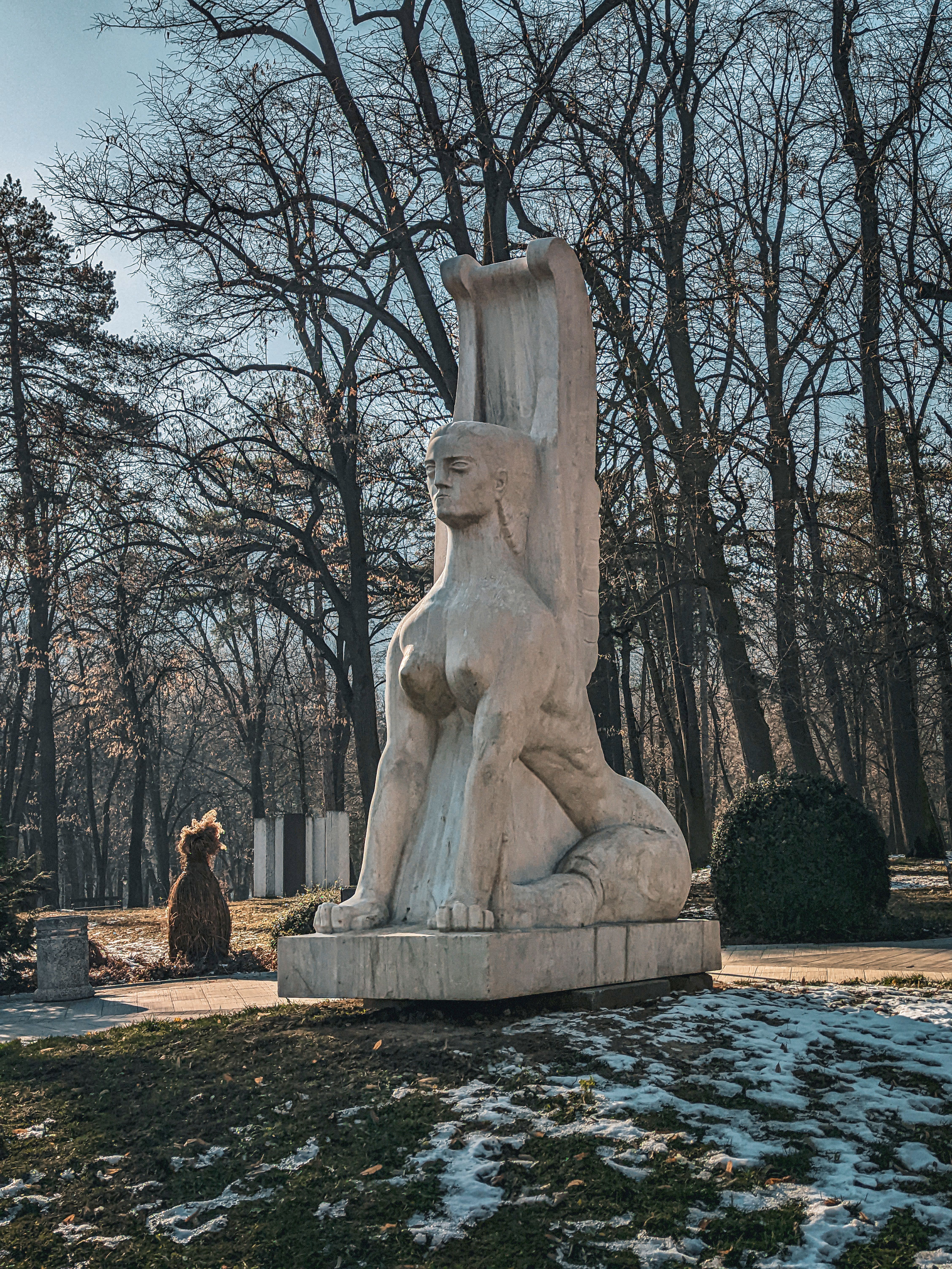 A Large Stone Statue in a Park in Winter · Free Stock Photo