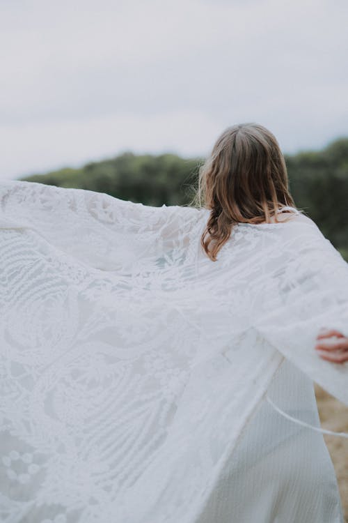 Woman in a Long White woman in a white lace long jacket