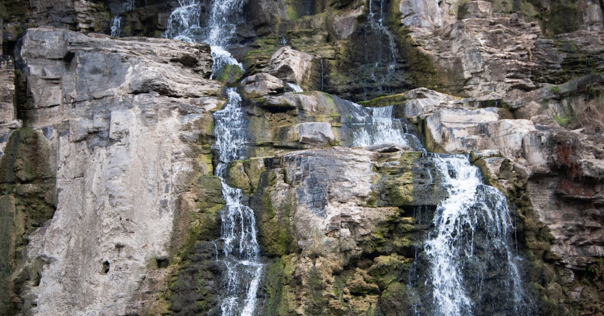 Timelaps Photo of White Green and Black Rock Falls during Daytime