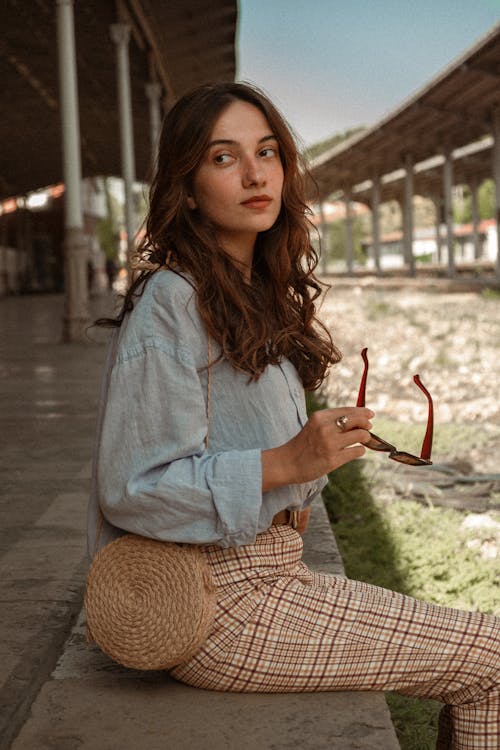 Beautiful Woman in Shirt Sitting on Edge