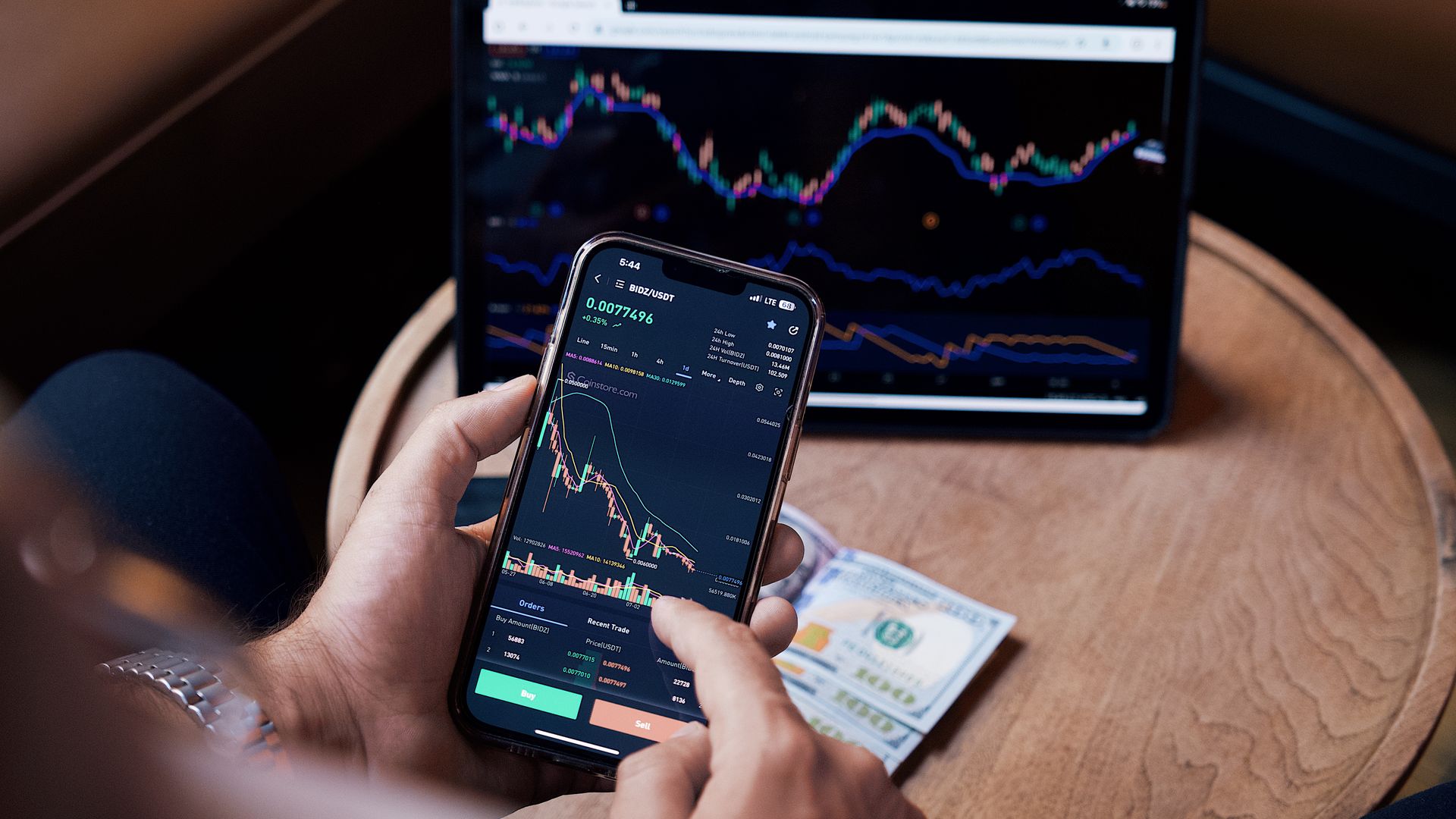 Modafinil for Stock Traders: Enhance Your Trading Edge Close-up of a person trading stocks using a smartphone and a tablet — modafinil for stock traders