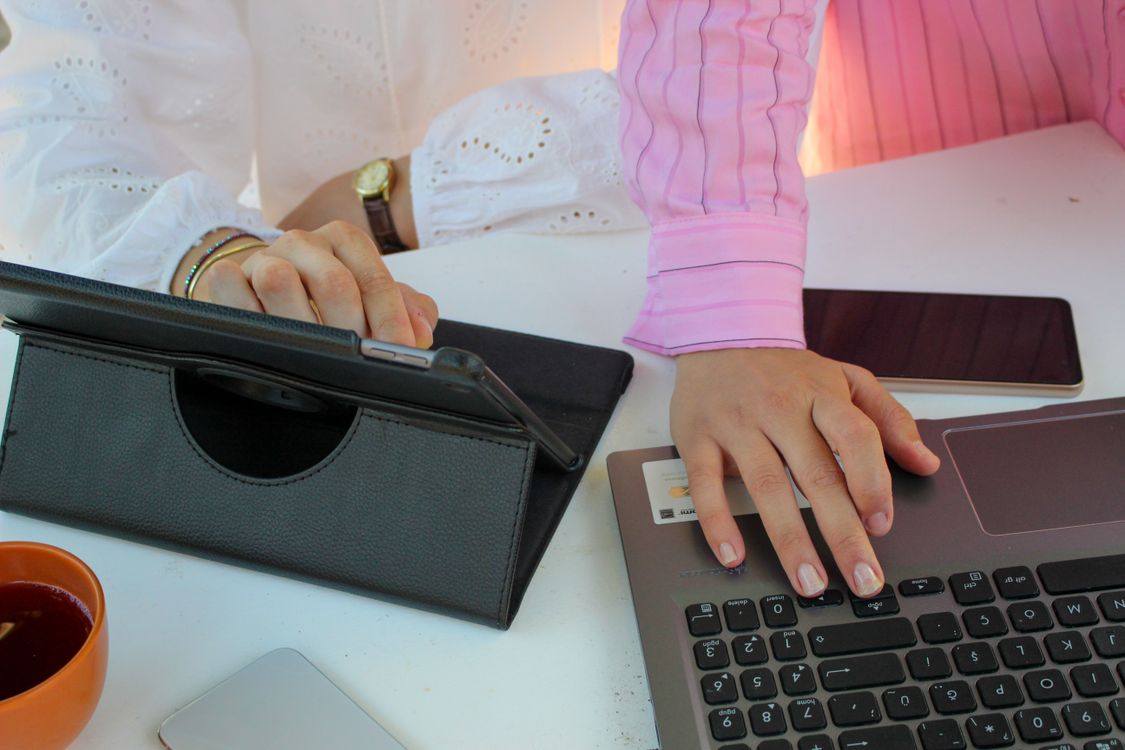 Office Workers Using a Laptop and a Tablet · Free Stock Photo