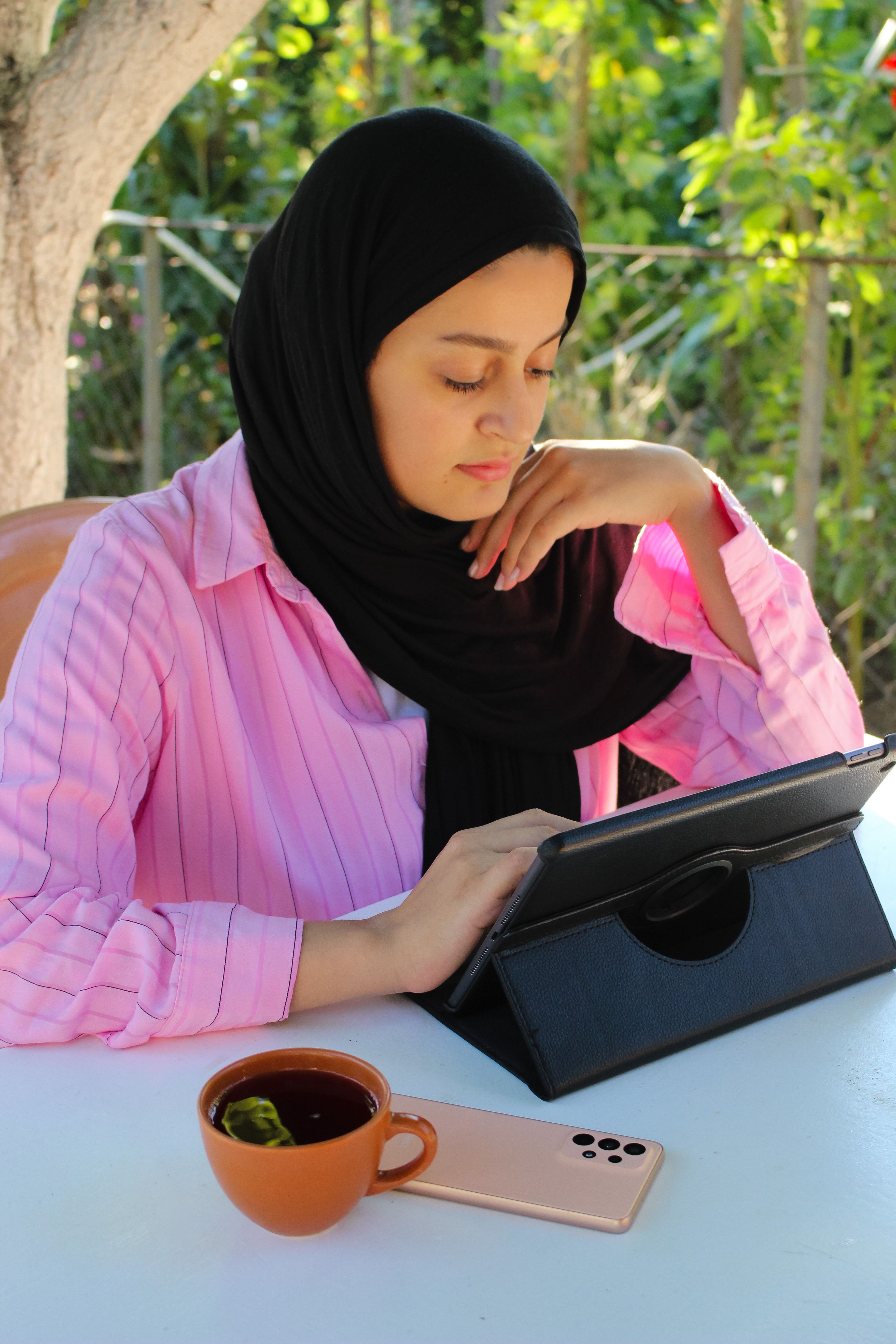 Woman in Hijab Using Tablet · Free Stock Photo
