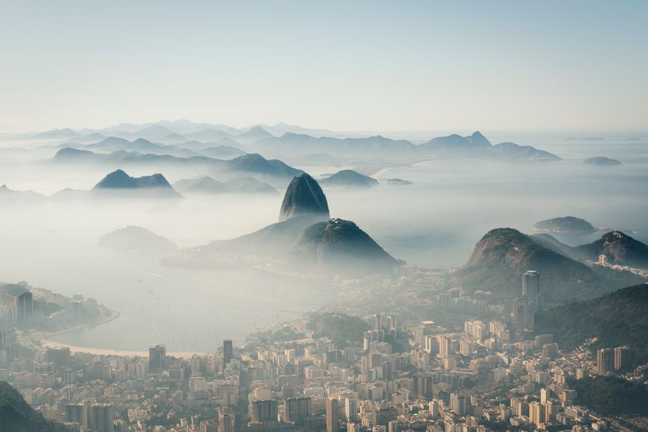 Discover the dramatic aerial view of Rio de Janeiro featuring Sugarloaf Mountain and the cityscape.