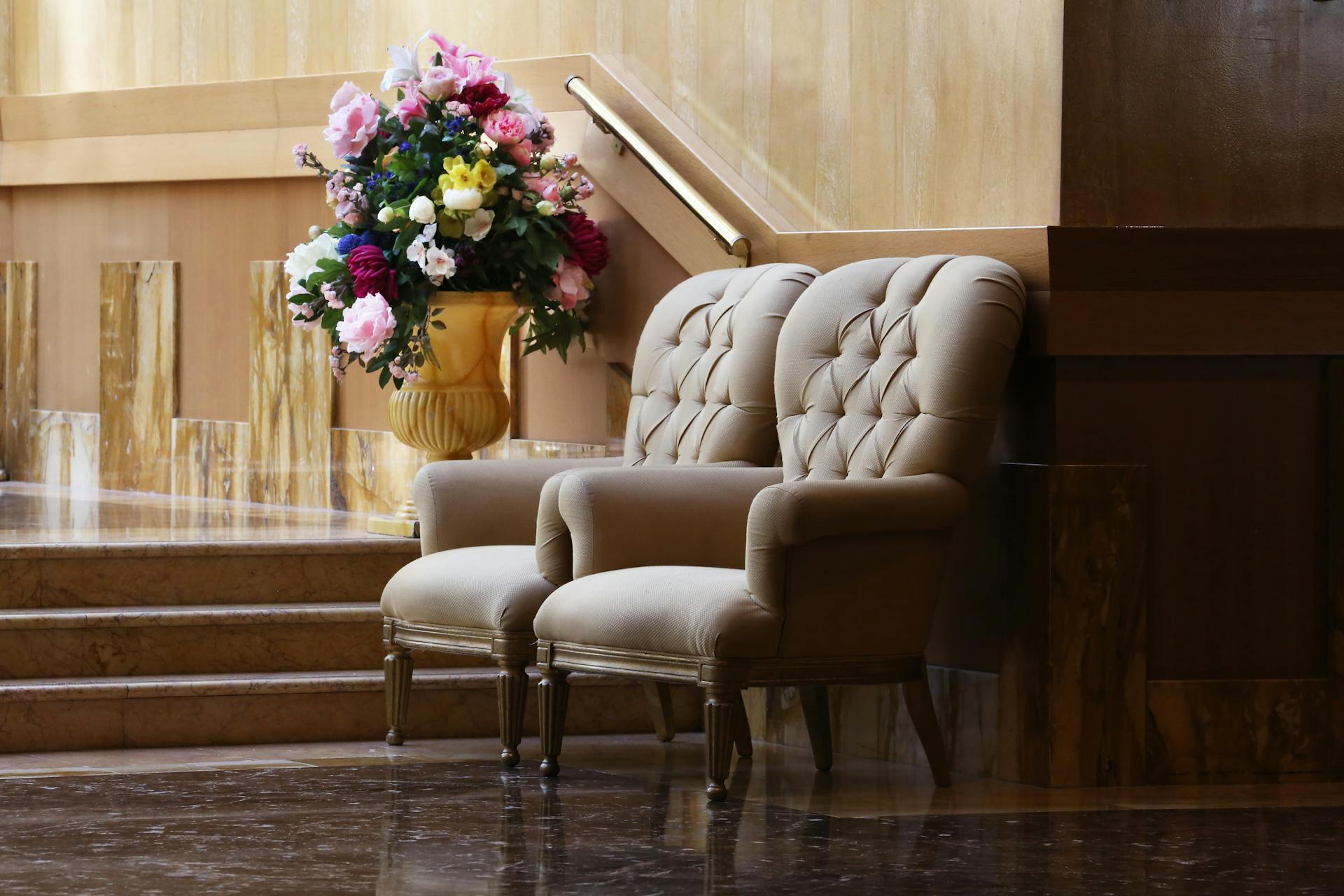 Two Beige Tufted Sofa Chairs