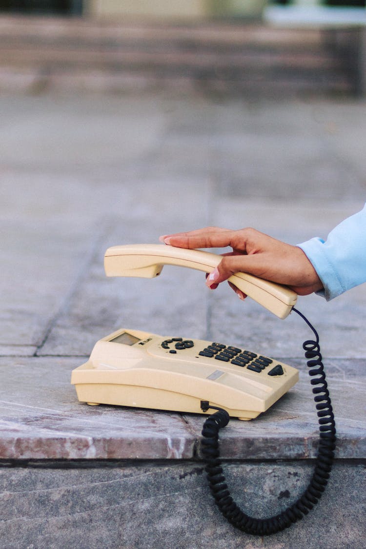 Person Holding Vintage Phone