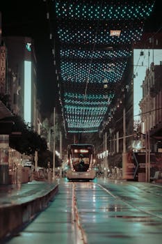 A mesmerizing night scene of a tram under illuminated lights on a Melbourne street.