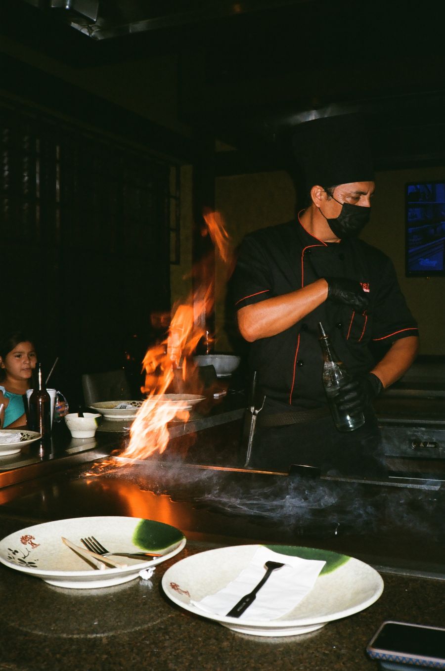 Chef performing live flame cooking for guests