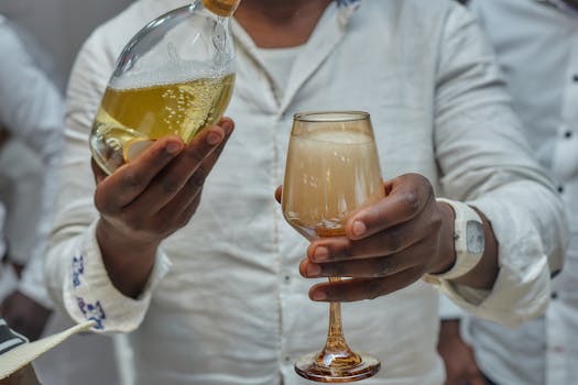 A close-up of a festive champagne pour at a celebration in Yaoundé, Cameroon.