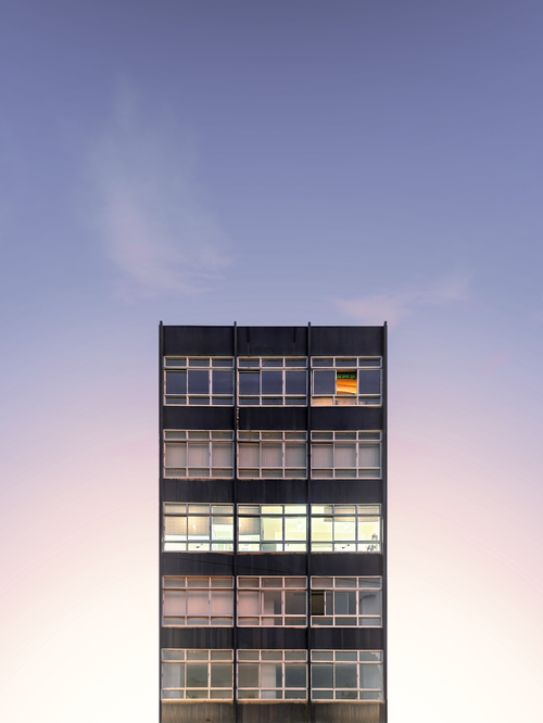 Free A vertical shot of a modern residential building against a twilight sky. Stock Photo
