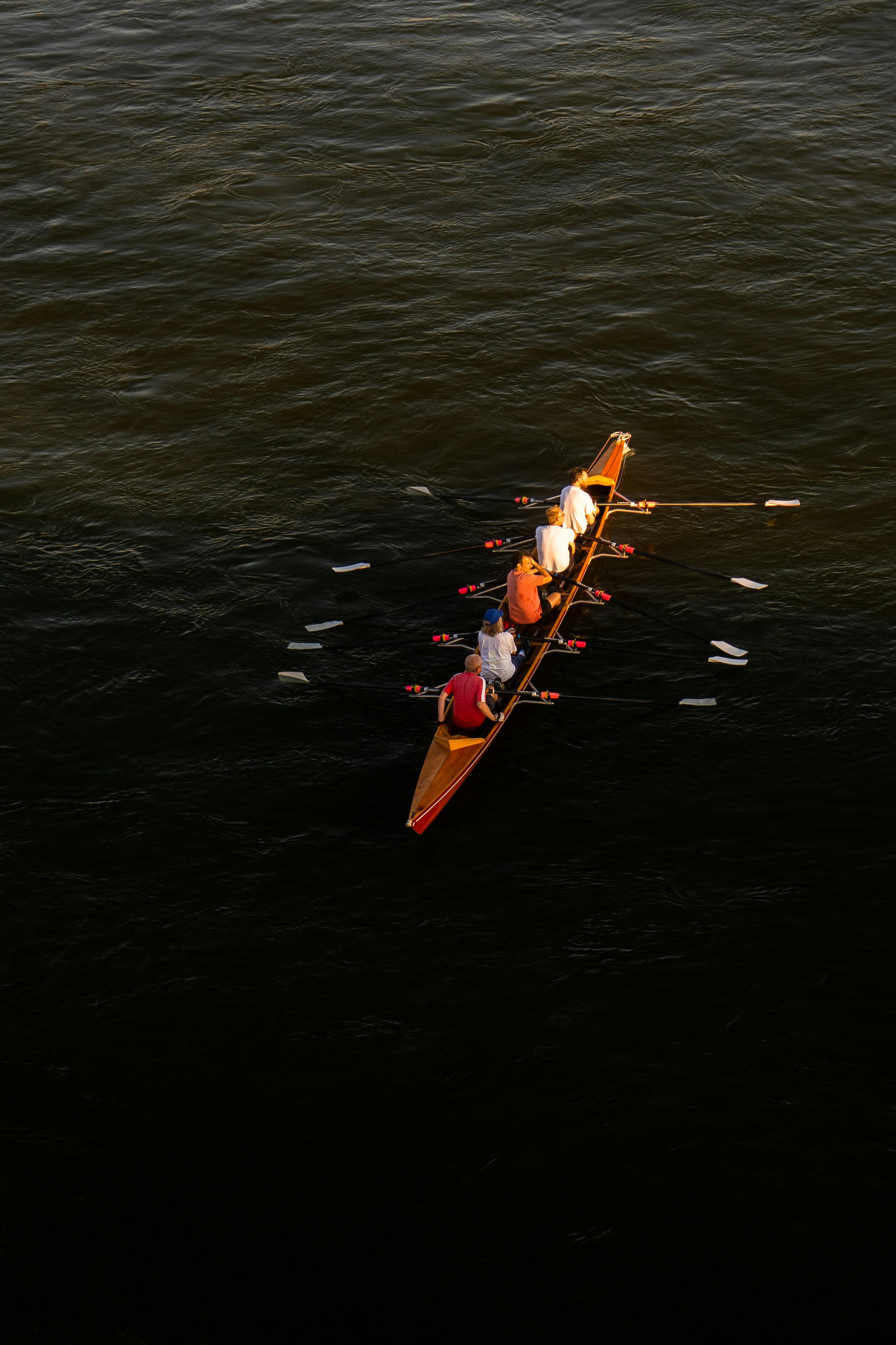 Top-down view of a team rowing boat on calm waters, Düsseldorf, Germany.