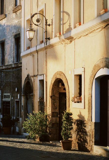 A picturesque view of a traditional European street with classic architectural details and warm lighting.