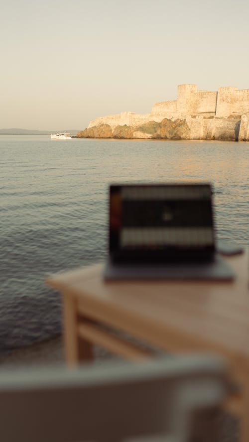 A Laptop on the Table with the View of the Sea 