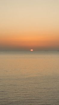 Peaceful sunset scene over the calm waters of Bozcaada, Türkiye.