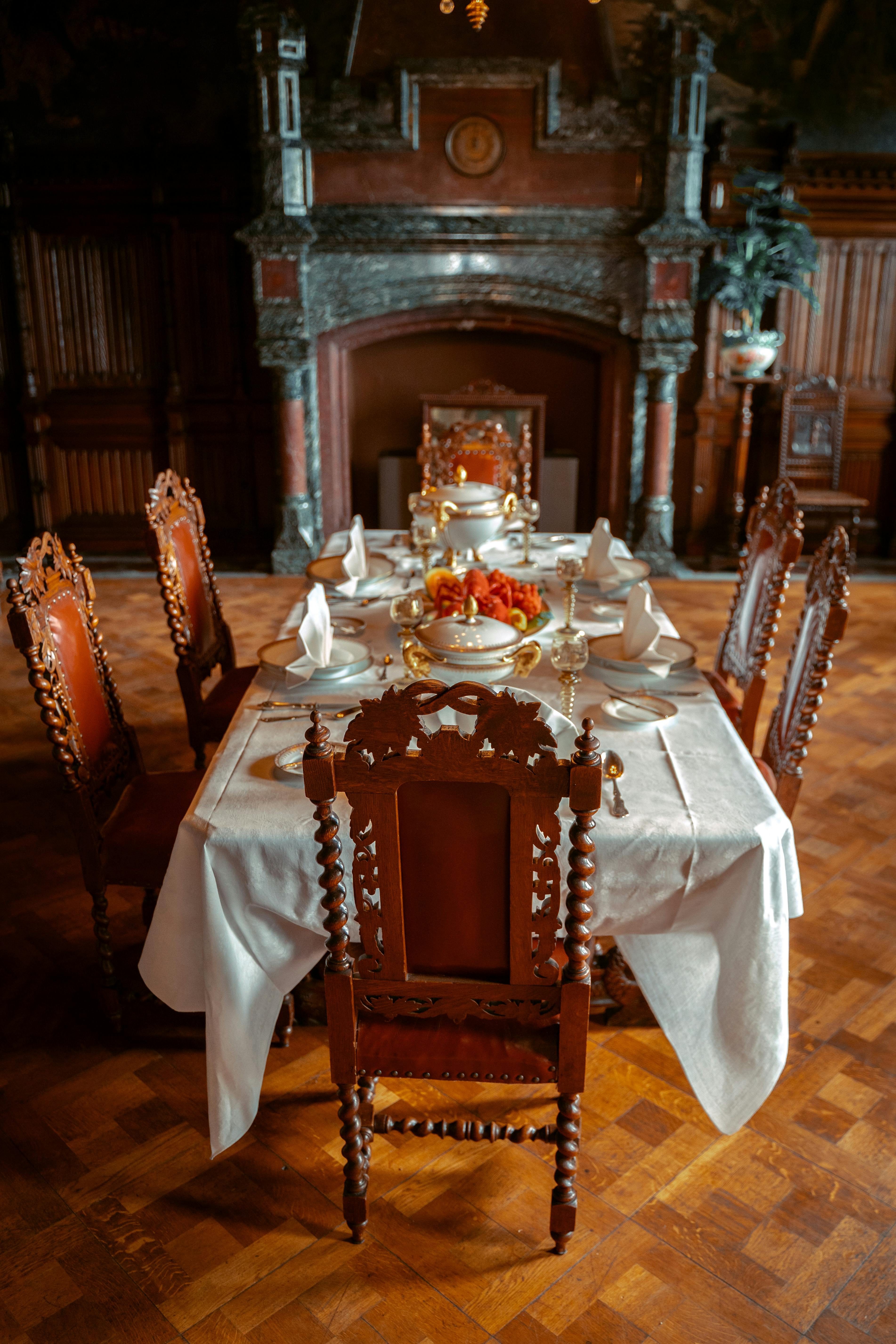 Vintage dining room with ornate chairs and fireplace in Drachenburg Castle, Germany.
