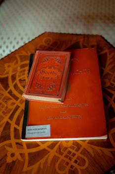 Vintage German books featuring Goethe on an ornate table. Perfect for literature enthusiasts.