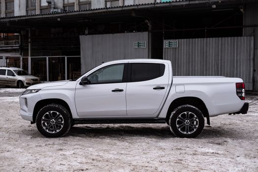 White Mitsubishi Triton Pickup Track in Industrial Area