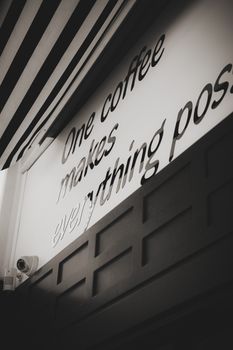 Black and white photo of a café wall with an inspiring coffee quote in Ankara, Türkiye.