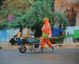 A construction worker pushes a wheelbarrow in an urban street in Addis Ababa, Ethiopia.
