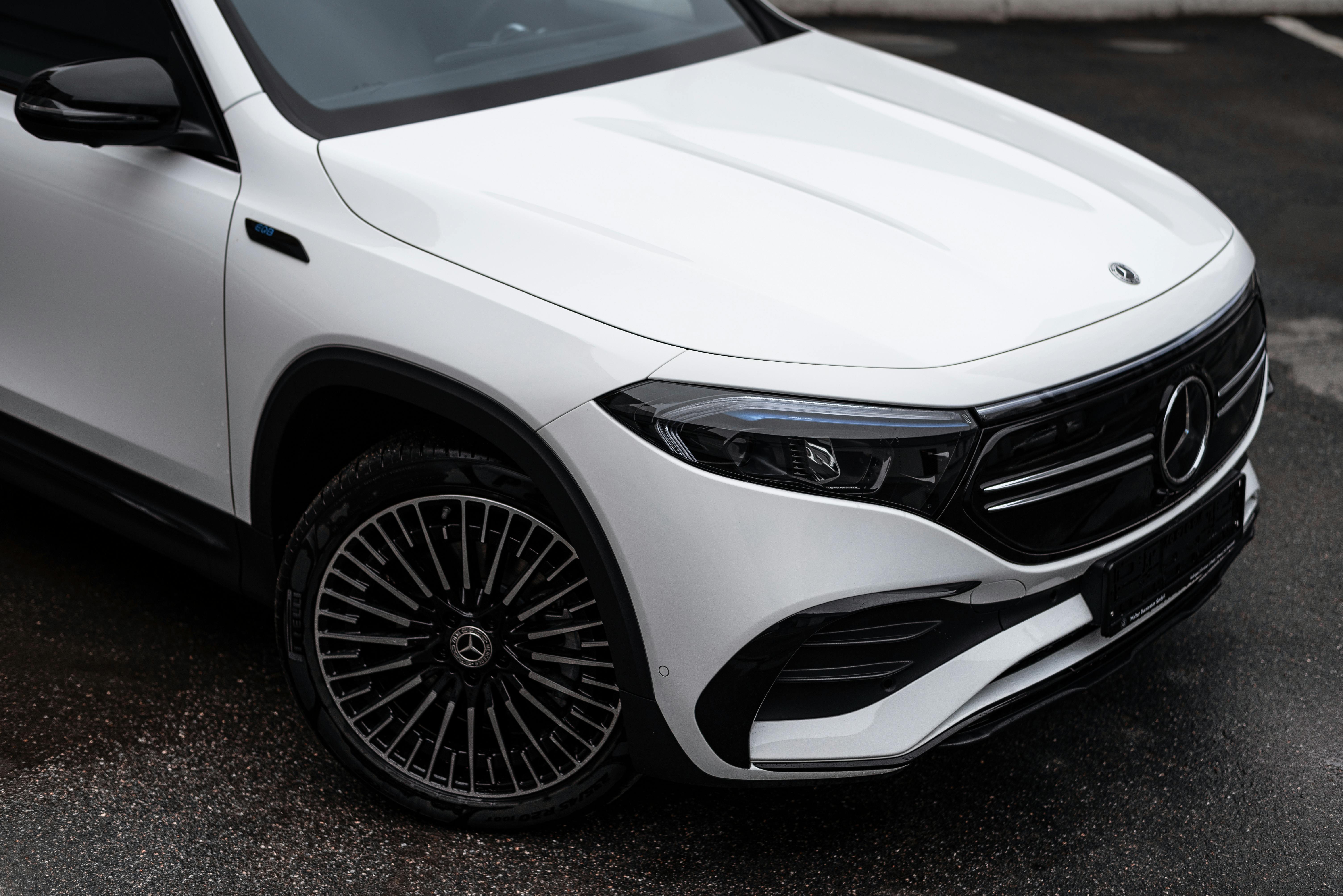 Elegant white Mercedes-Benz EQB SUV parked outdoors, showcasing modern design.