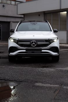 Front view of a white Mercedes-Benz EQB SUV parked in a city environment.