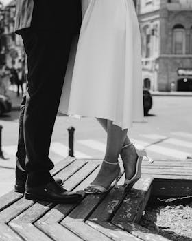 Artistic black and white photo of a bride and groom in an urban city setting.