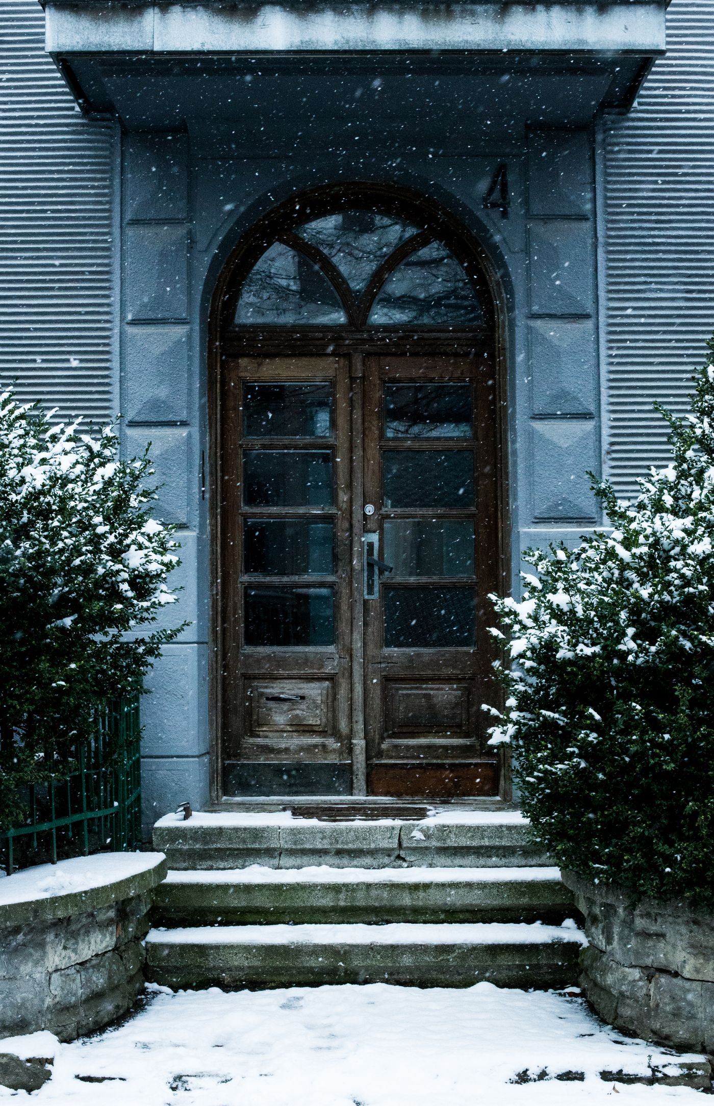 A wooden doorway covered in snow during winter