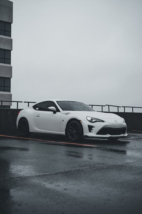 White Toyota Parked in Rain