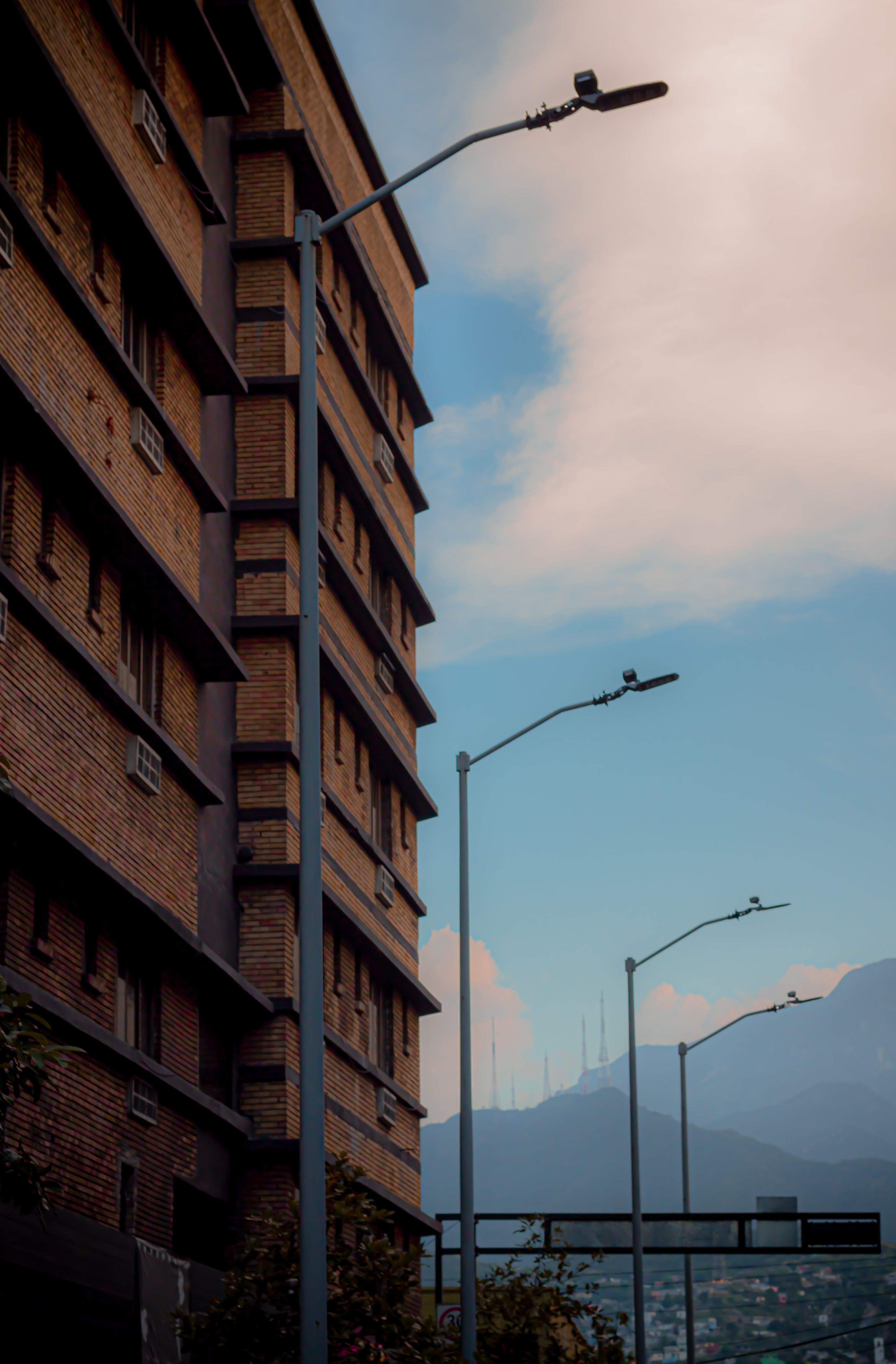 Row of Street Lamps in Front of a Brick Apartment Building · Free Stock ...
