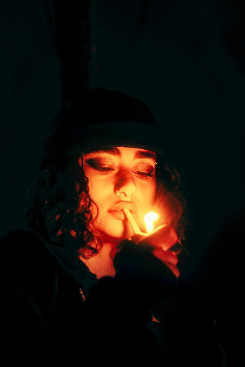 Young Woman Lighting a Cigarette